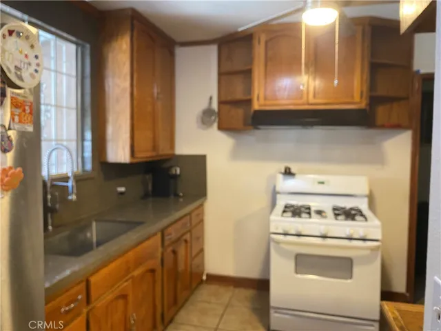 a kitchen with stainless steel appliances granite countertop a sink stove and microwave