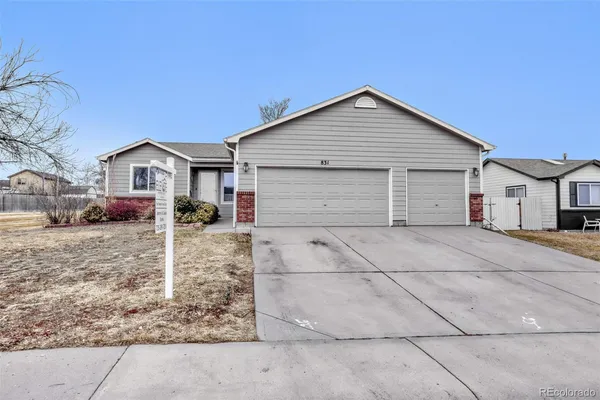 a view of house with a yard and garage