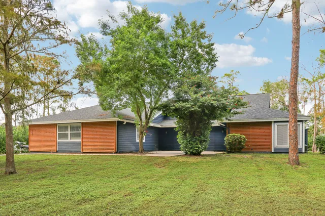 a front view of house with yard and trees