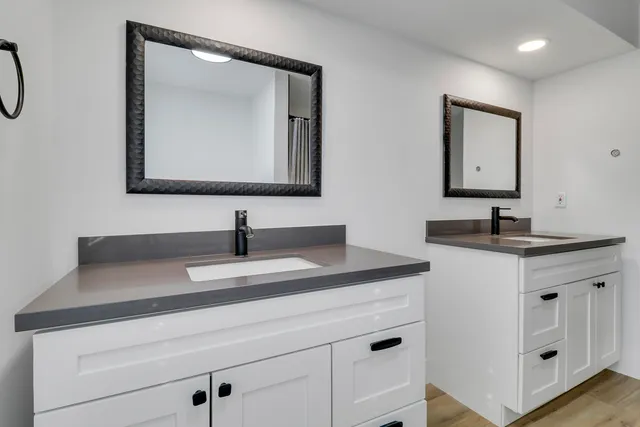 a bathroom with a sink vanity and a mirror