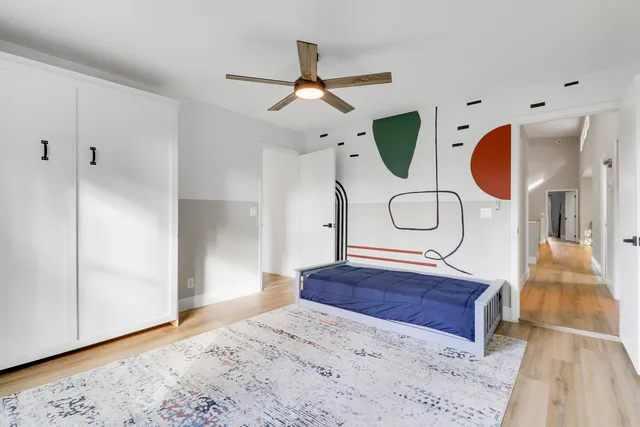 a bedroom with a large bed and a large window