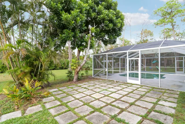 a view of a yard with basketball court
