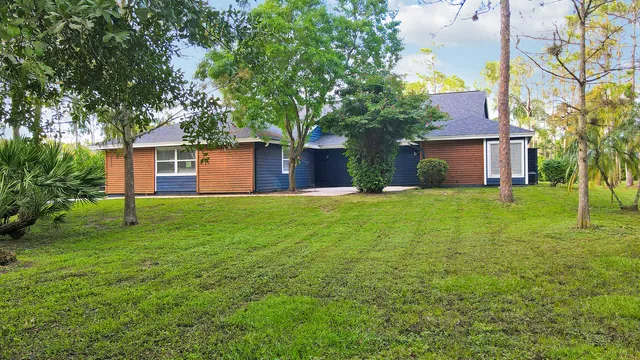 a front view of house with yard and trees