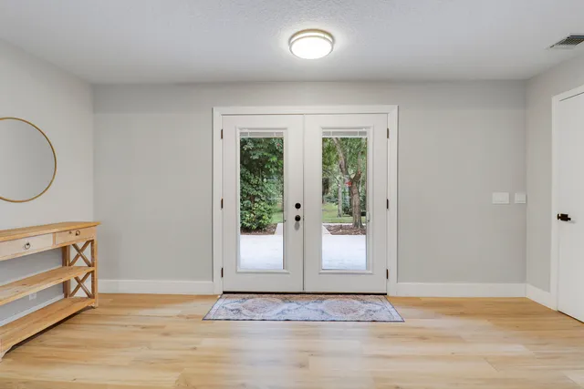 a view of a livingroom with wooden floor and a window