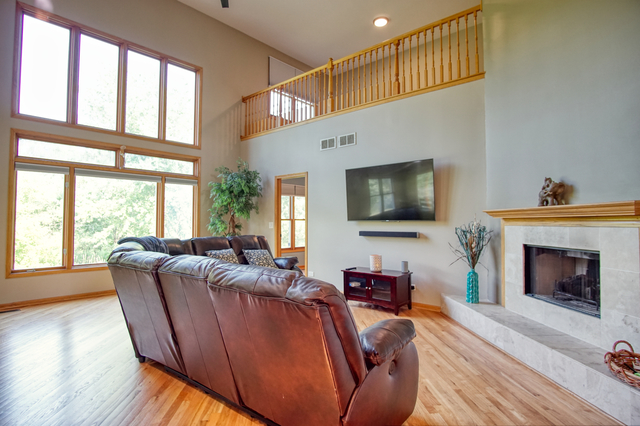 115 North Prospect Avenue Streamwood, IL 60107 - Photo 12 of 41 a living room with furniture a flat screen tv and a fireplace