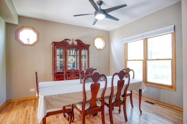 115 North Prospect Avenue Streamwood, IL 60107 - Photo 16 of 41 a view of a dining room with furniture window and wooden floor