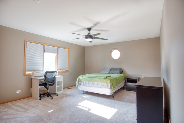 115 North Prospect Avenue Streamwood, IL 60107 - Photo 29 of 41 a bedroom with a bed and a chandelier