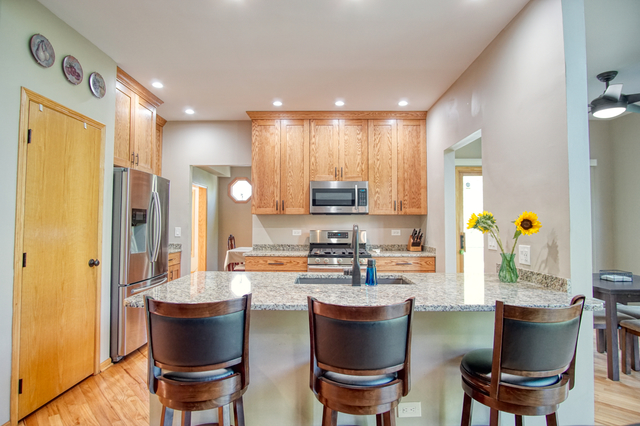 115 North Prospect Avenue Streamwood, IL 60107 - Photo 4 of 41 a kitchen with a dining table chairs and appliances