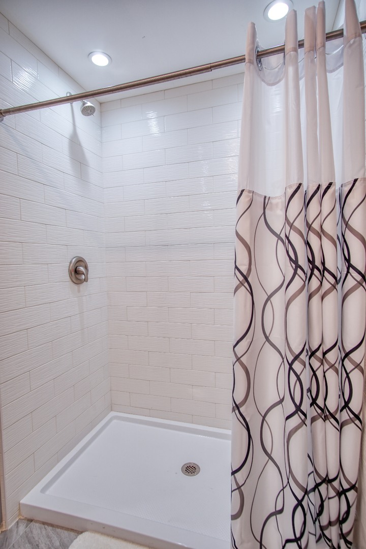 115 North Prospect Avenue Streamwood, IL 60107 - Photo 33 of 41 a bathroom with a shower curtain and a shower