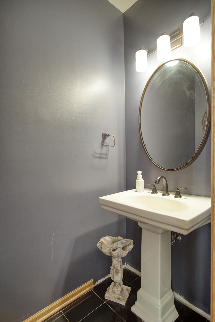115 North Prospect Avenue Streamwood, IL 60107 - Photo 35 of 41 a bathroom with a sink mirror and toilet