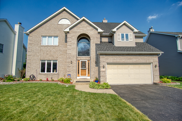 115 North Prospect Avenue Streamwood, IL 60107 - Photo 41 of 41 a front view of a house with garden