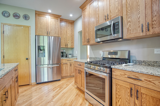 115 North Prospect Avenue Streamwood, IL 60107 - Photo 8 of 41 a kitchen with stainless steel appliances granite countertop a refrigerator stove and microwave