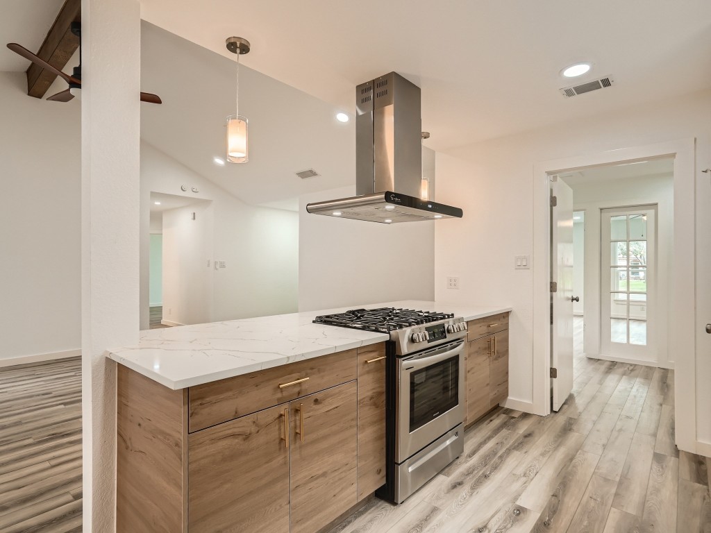 a kitchen with a stove and a sink