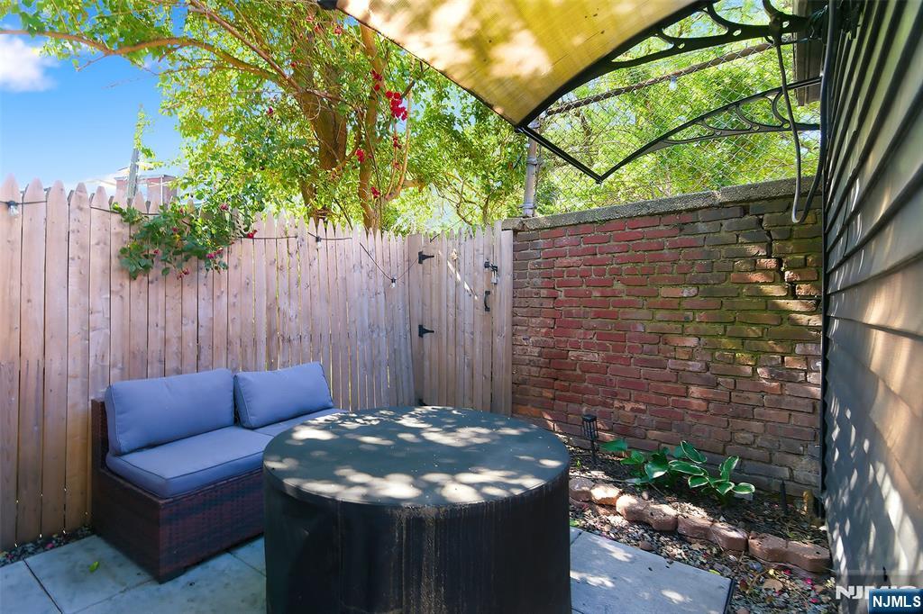 22 8th Avenue Newark, NJ 07104 - Photo 26 of 26 a backyard of a house with table and chairs