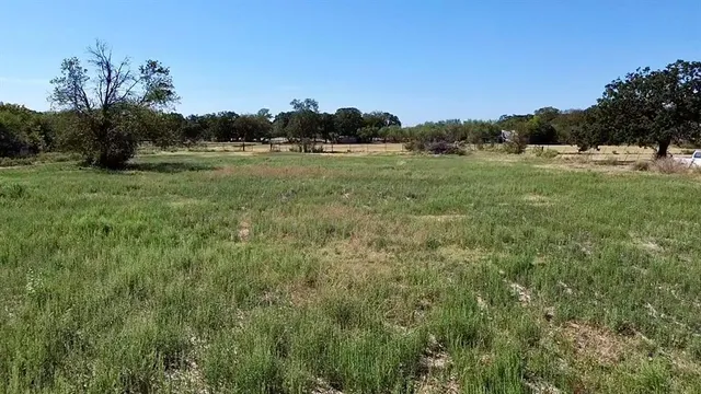 a view of a lake with a yard