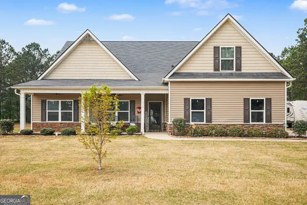 a front view of a house with a yard