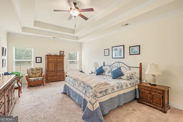 a bedroom with a bed and a couch