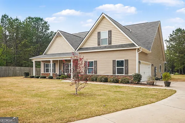 a front view of a house with outdoor seating