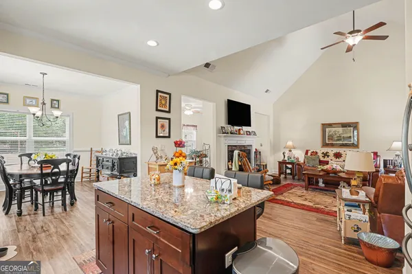 a dining room with furniture a chandelier and wooden floor