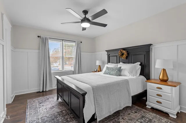 a bedroom with a bed a window and dresser