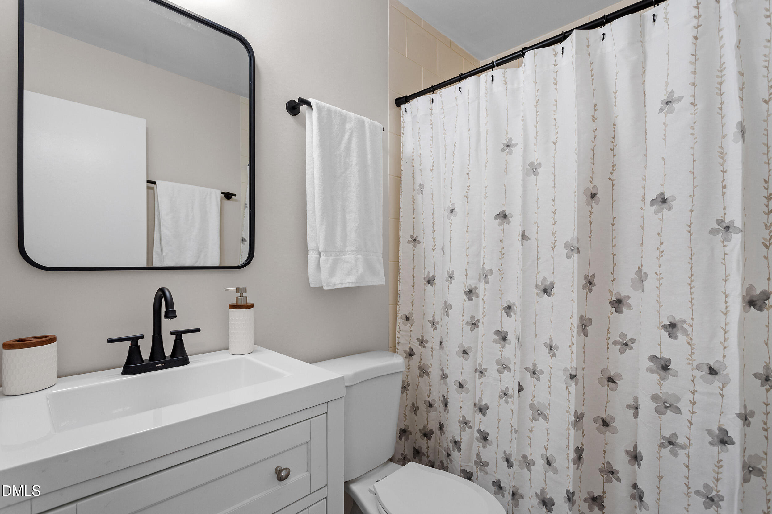 3525 Castlegate Drive Raleigh, NC 27616 - Photo 10 of 15 a bathroom with a sink a toilet and a mirror
