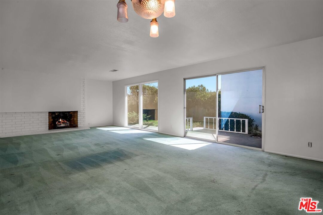 29636 Stonecrest Road Rancho Palos Verdes, CA 90275 - Photo 7 of 32 a view of an empty room with a fireplace and a window
