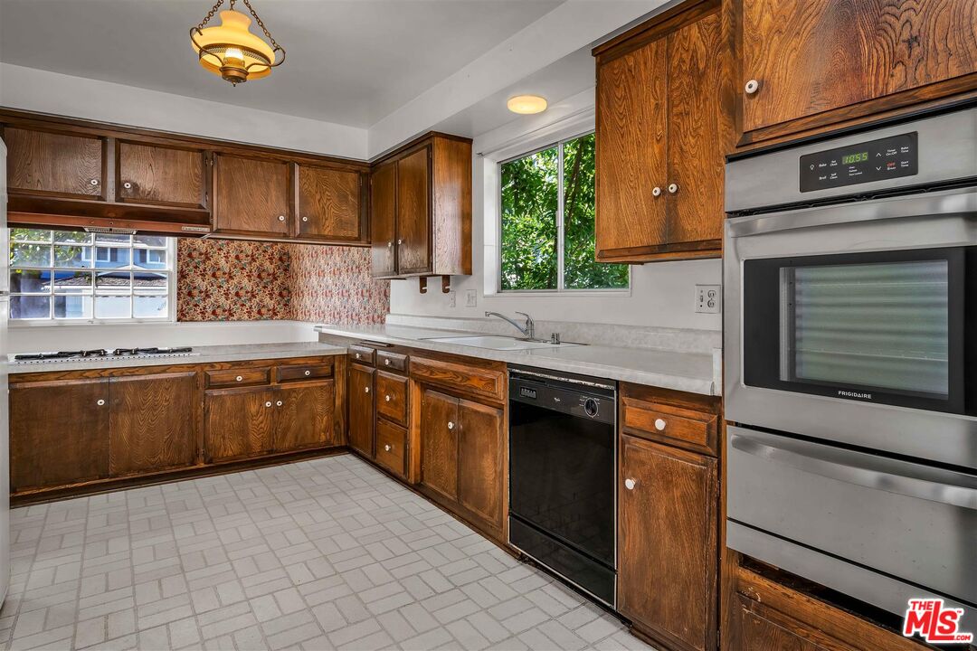 29636 Stonecrest Road Rancho Palos Verdes, CA 90275 - Photo 10 of 32 a kitchen with stainless steel appliances granite countertop a stove a sink and a microwave