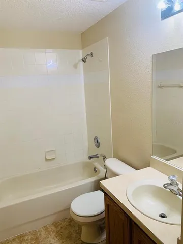 a bathroom with a sink a toilet and a bathtub