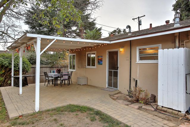 a view of a patio with table and chairs and potted plants