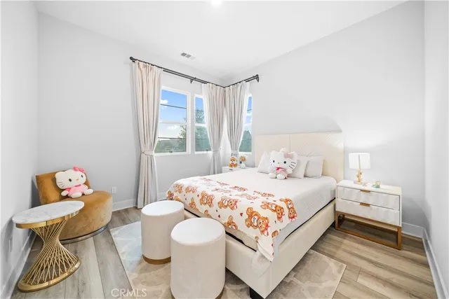 a bedroom with a bed and wooden floor