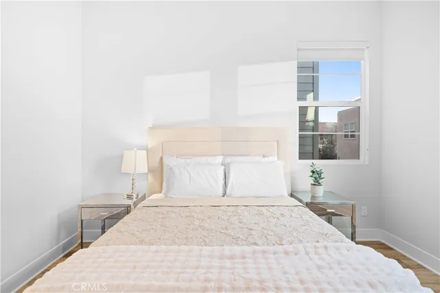 a bedroom with a large bed and a window