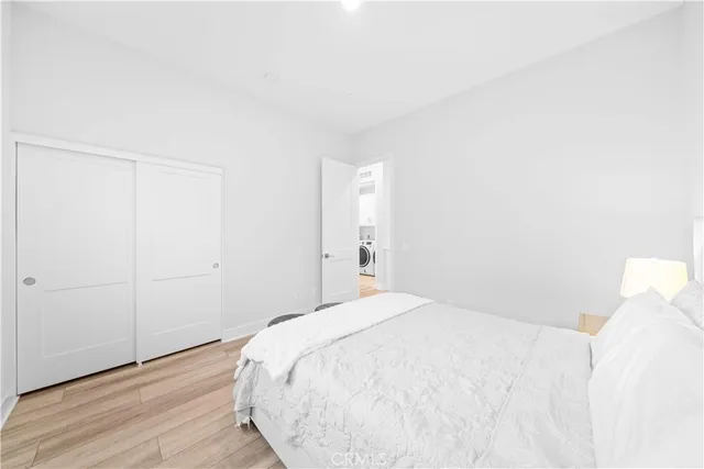 a bedroom with a bed and a night stand