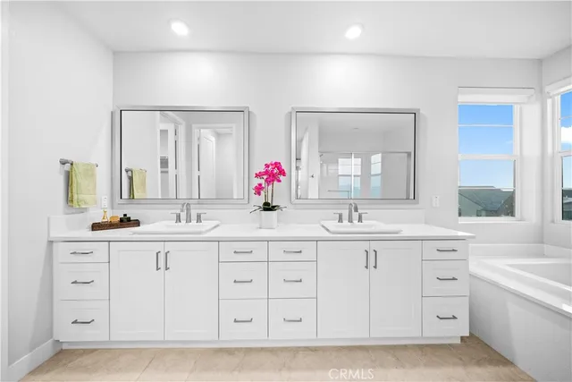 a bathroom with double sink and a mirror