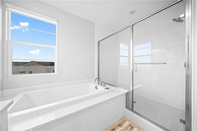 a bathroom with a bathtub and a shower