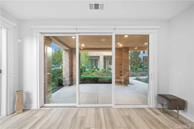 a view of a room with wooden floor and outdoor space