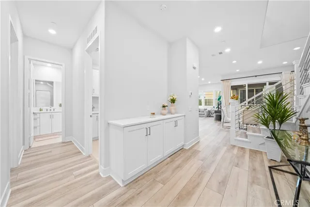 a large white room with wooden floor