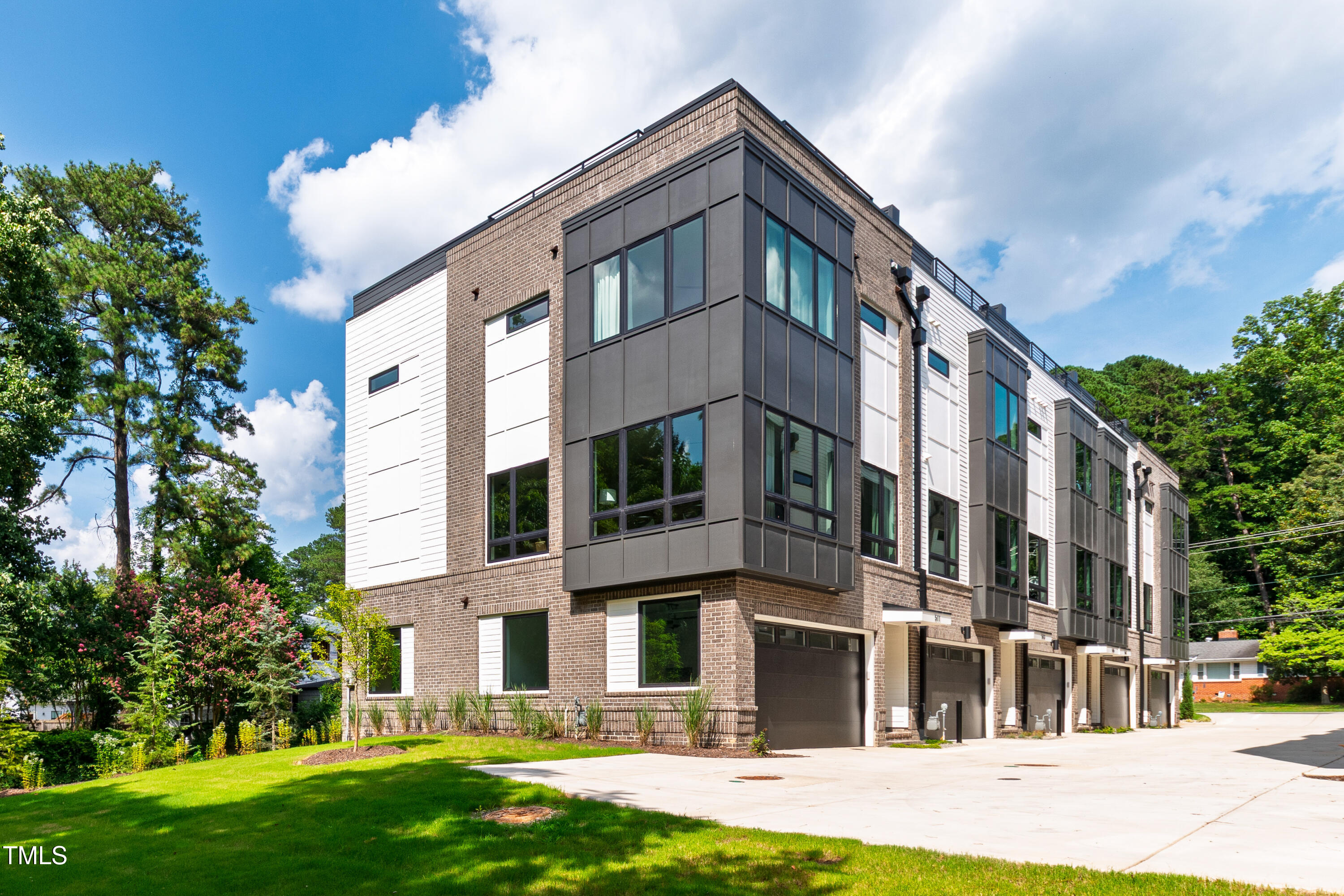 a front view of a building with a garden