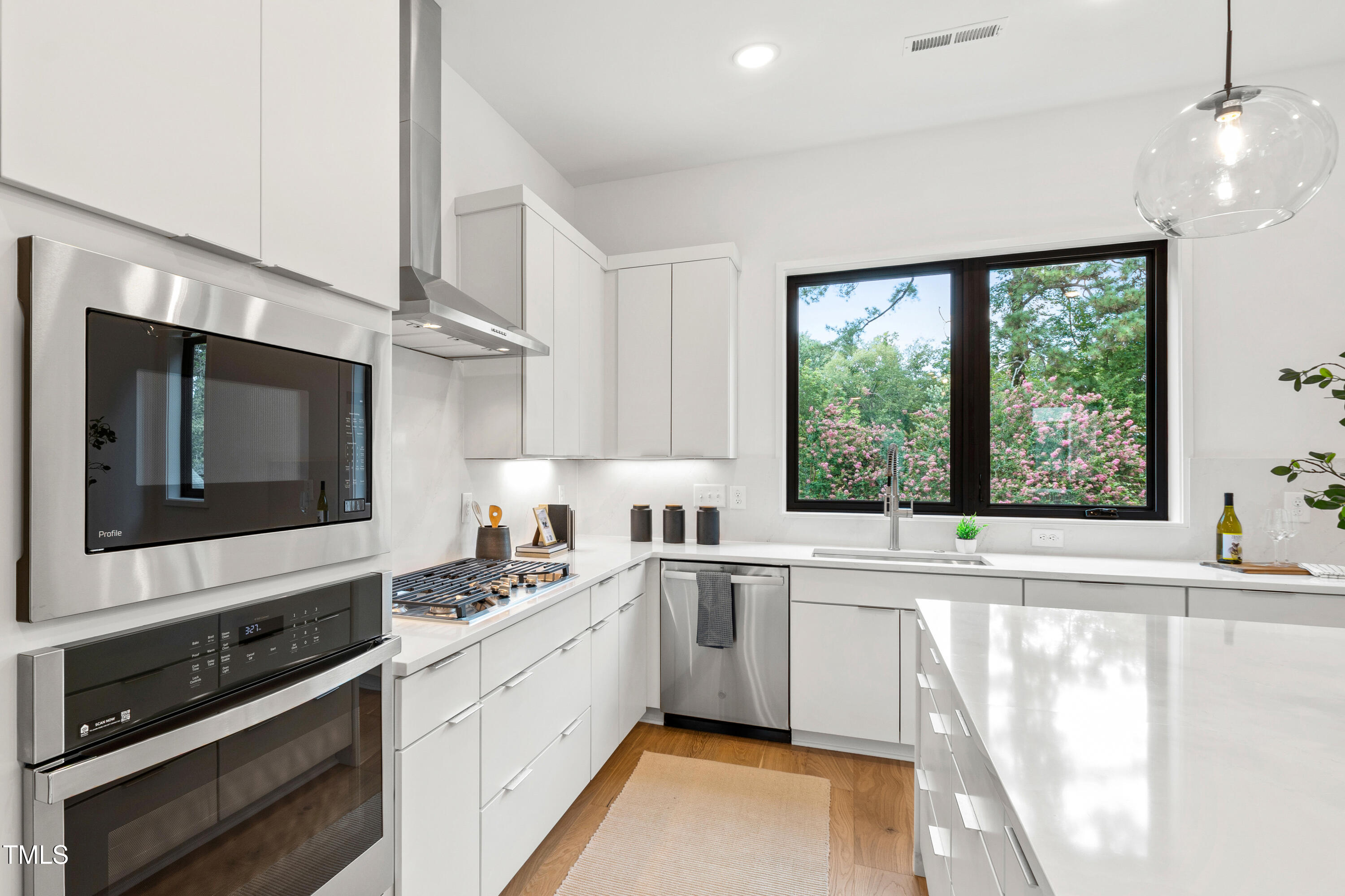 511 Edgecreek Court Raleigh, NC 27604 - Photo 14 of 58 a kitchen with a sink wooden floor and cabinets