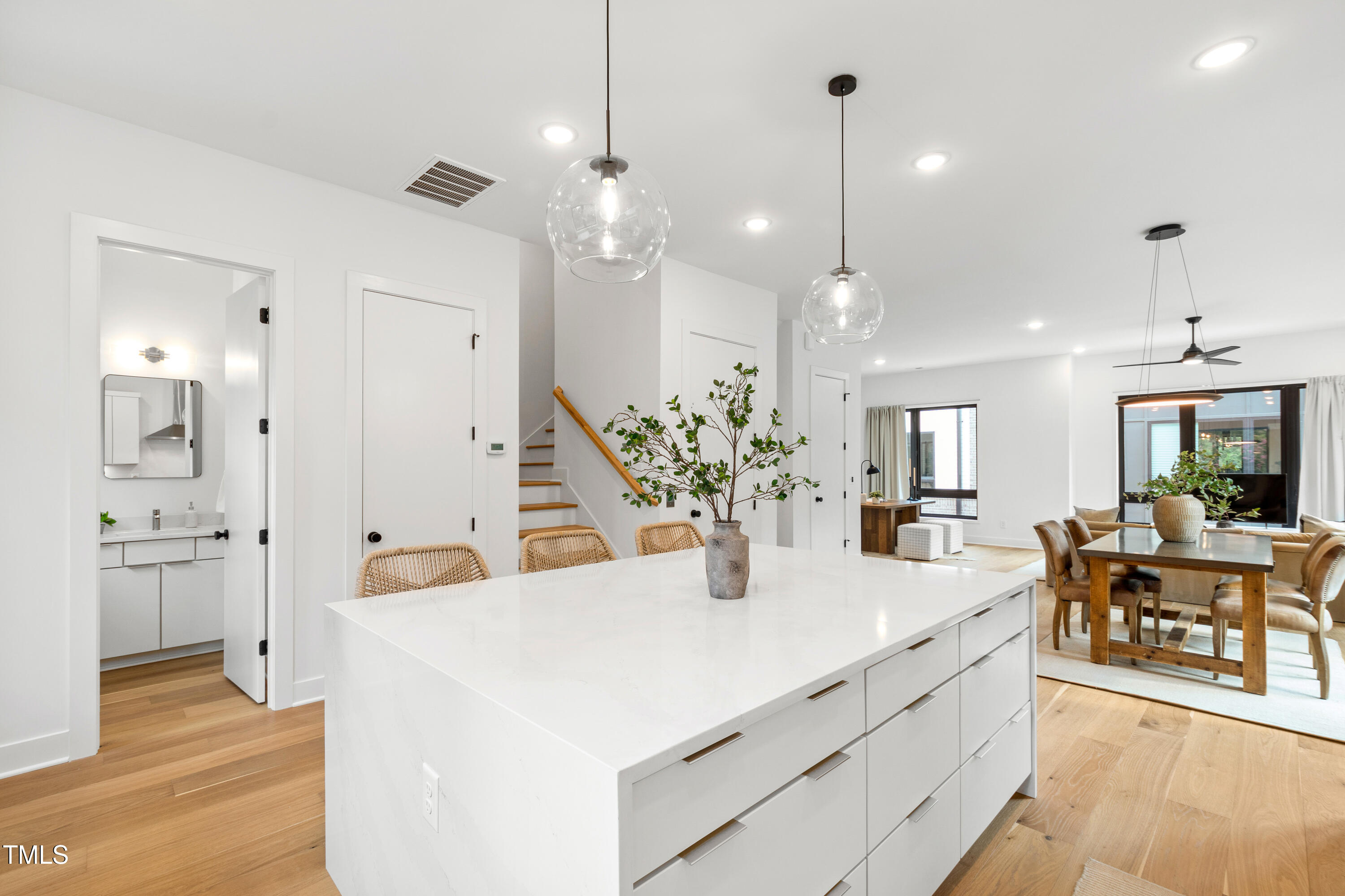 511 Edgecreek Court Raleigh, NC 27604 - Photo 15 of 58 a view of a dining room and livingroom with furniture wooden floor a chandelier