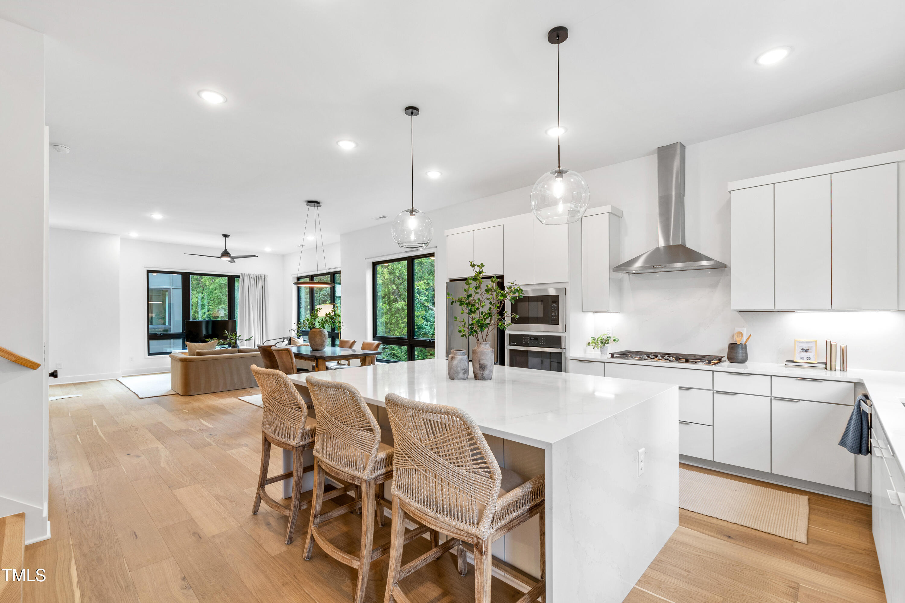 511 Edgecreek Court Raleigh, NC 27604 - Photo 16 of 58 a large kitchen with kitchen island a large island a sink a stove and a wooden floors