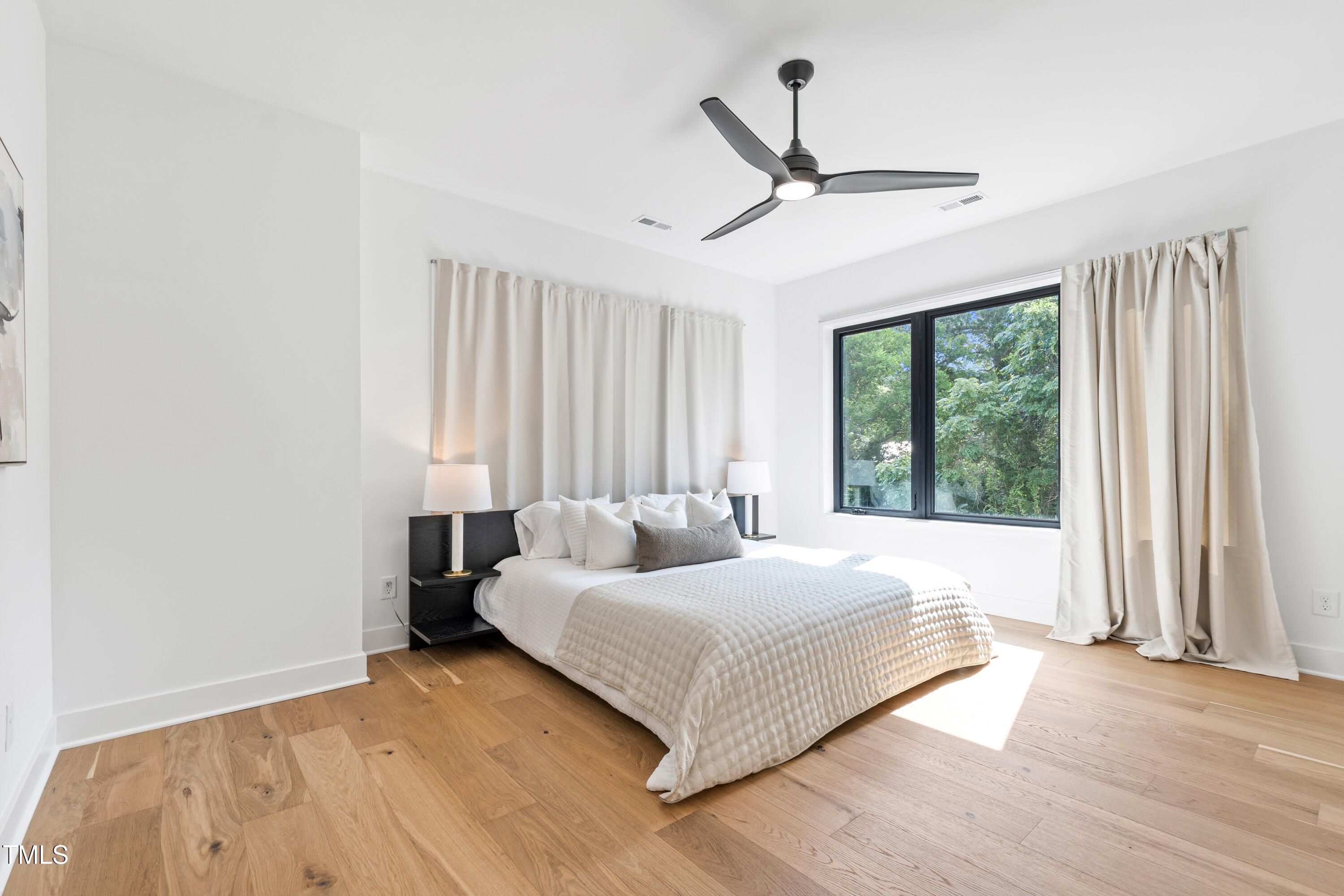 511 Edgecreek Court Raleigh, NC 27604 - Photo 31 of 58 a bedroom with a bed and large window