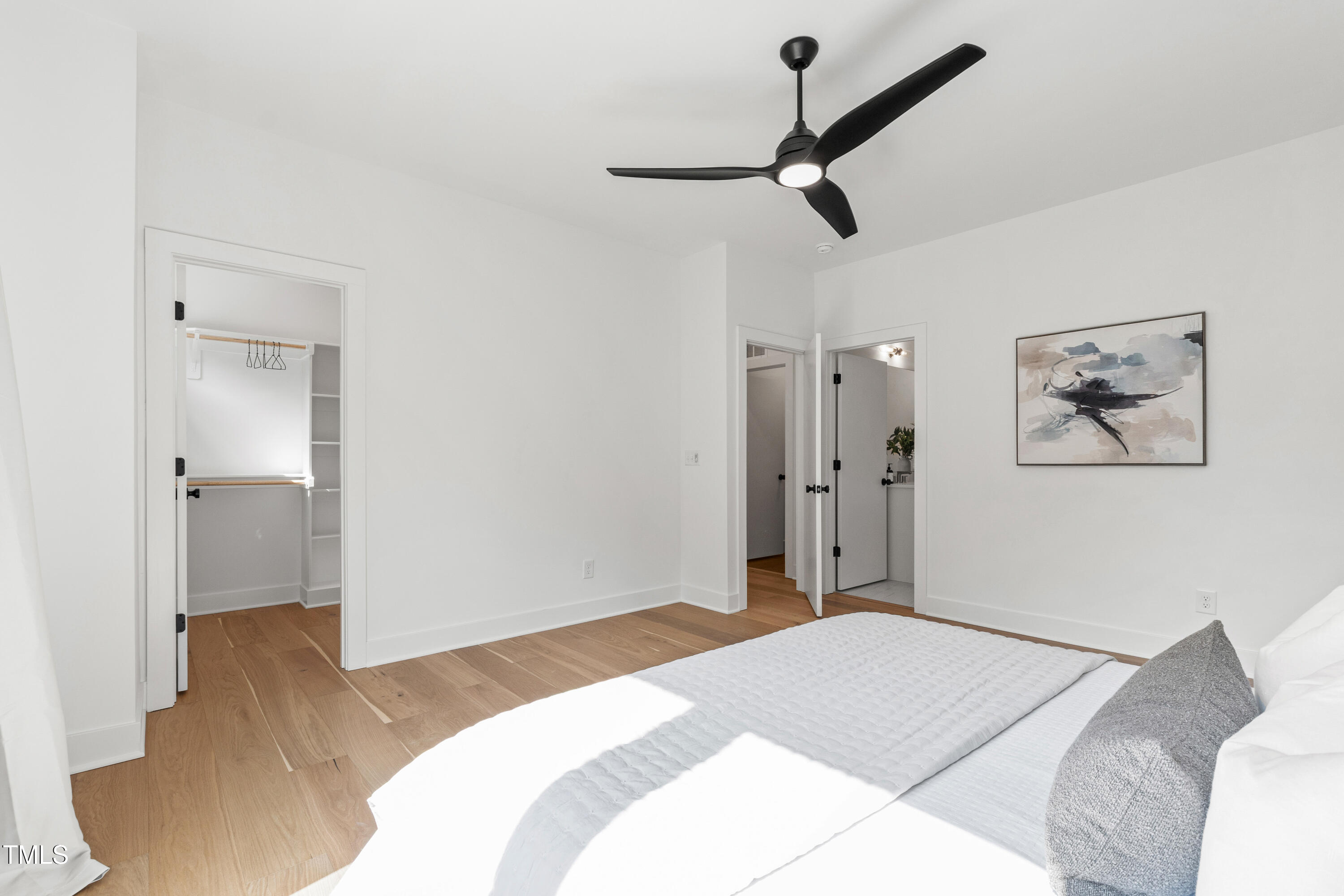 511 Edgecreek Court Raleigh, NC 27604 - Photo 32 of 58 a bedroom with a bed and a chandelier