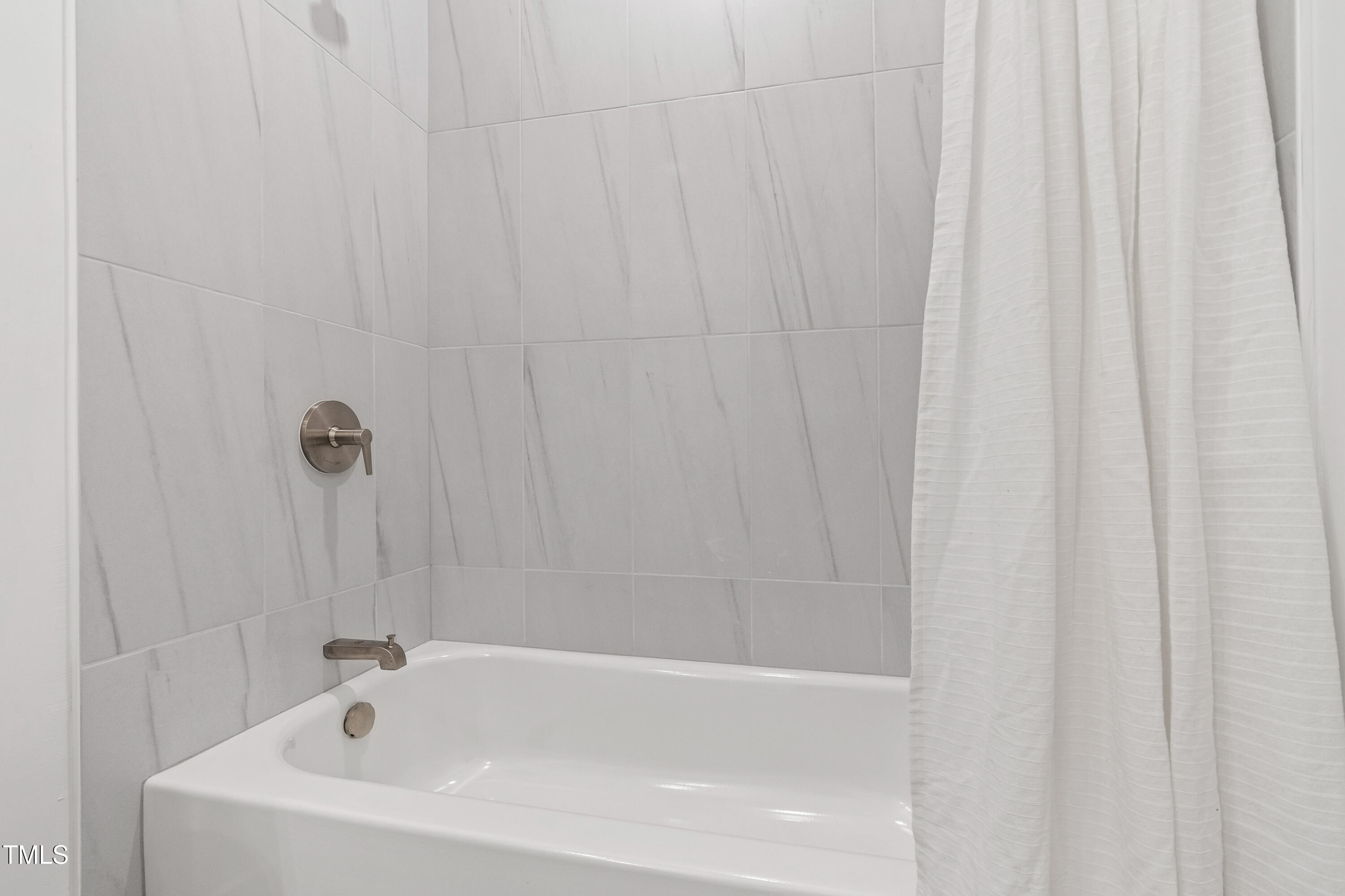 511 Edgecreek Court Raleigh, NC 27604 - Photo 39 of 58 a white bath tub with a shower curtain