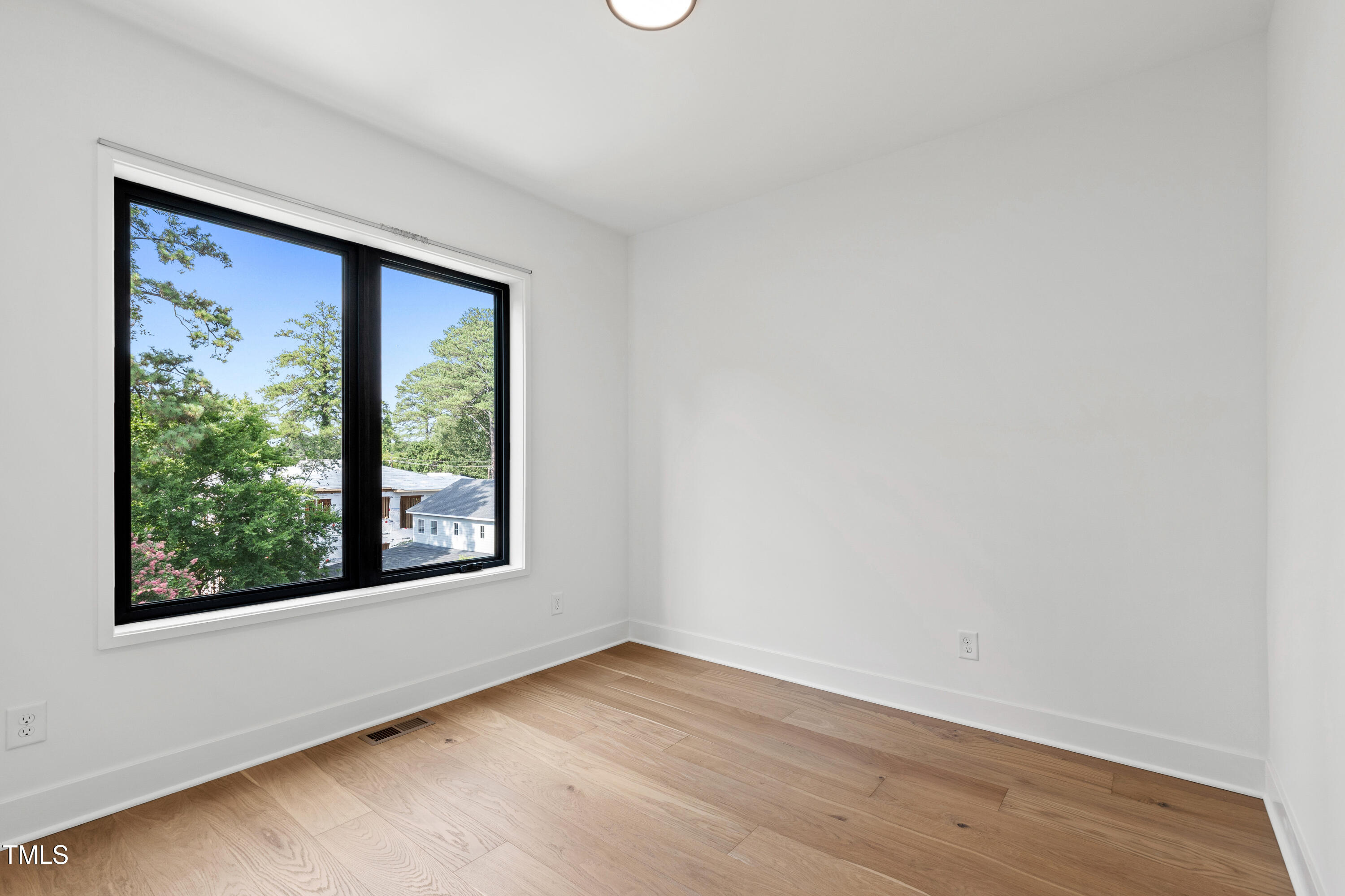 511 Edgecreek Court Raleigh, NC 27604 - Photo 40 of 58 a view of an empty room with wooden floor and a window