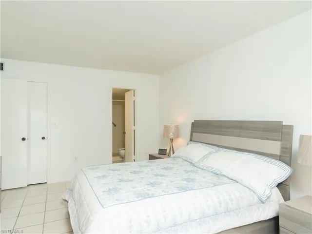 a bedroom with a bed and a mirror