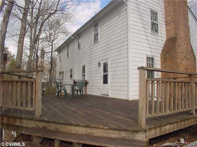 3017 Williamswood Road Richmond, VA 23235 - Photo 11 of 12 a view of a house with wooden deck and furniture