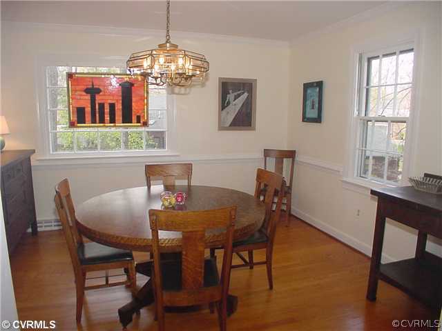 3017 Williamswood Road Richmond, VA 23235 - Photo 3 of 12 a view of a dining room with furniture a chandelier and wooden floor