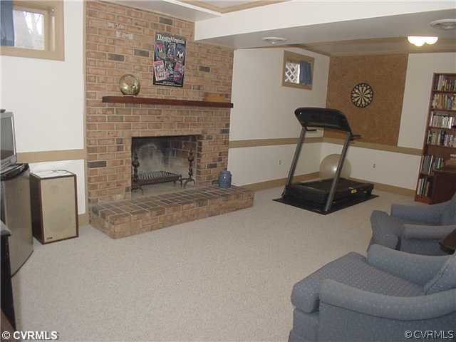 3017 Williamswood Road Richmond, VA 23235 - Photo 7 of 12 a living room with furniture a flat screen tv and a fireplace
