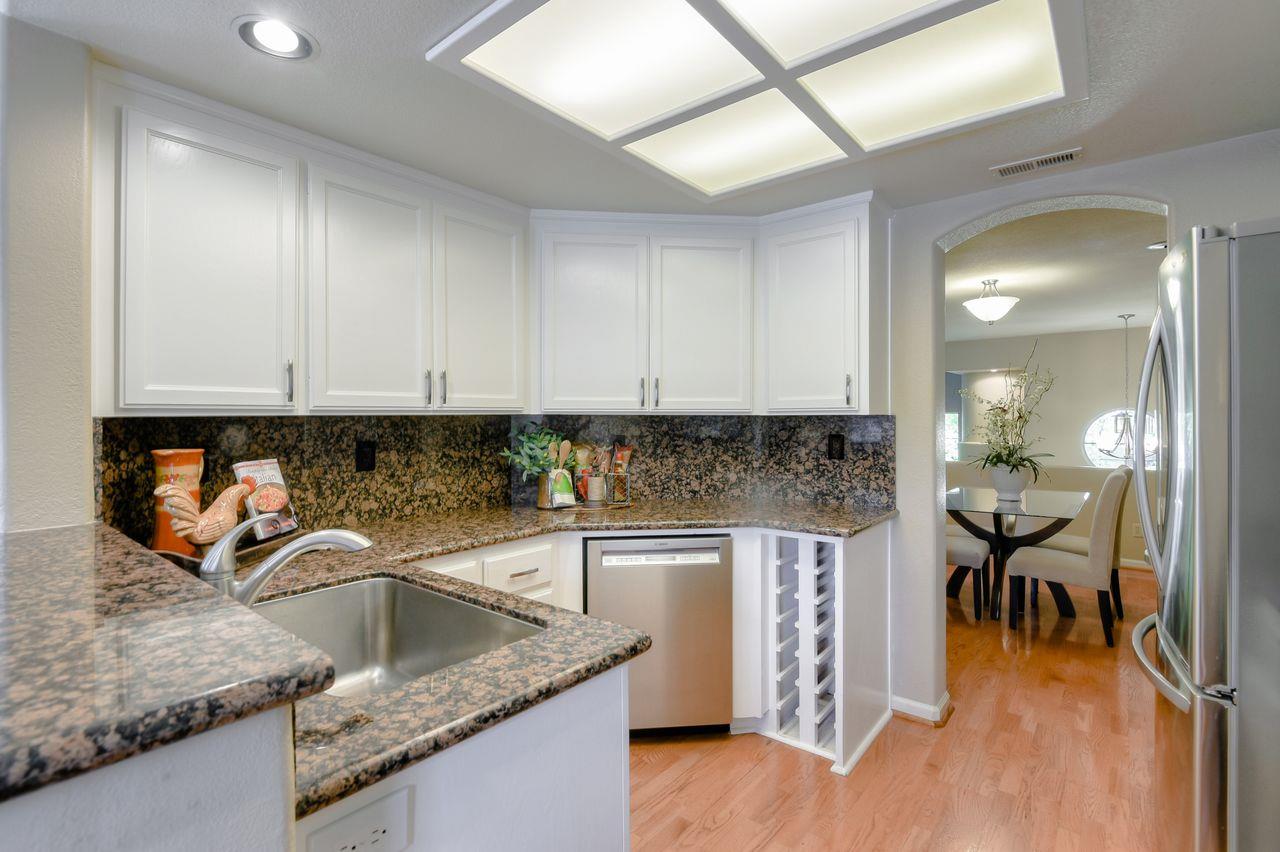 463 Mill River Lane San Jose, CA 95134 - Photo 11 of 30 a kitchen with stainless steel appliances granite countertop a sink stove and cabinets