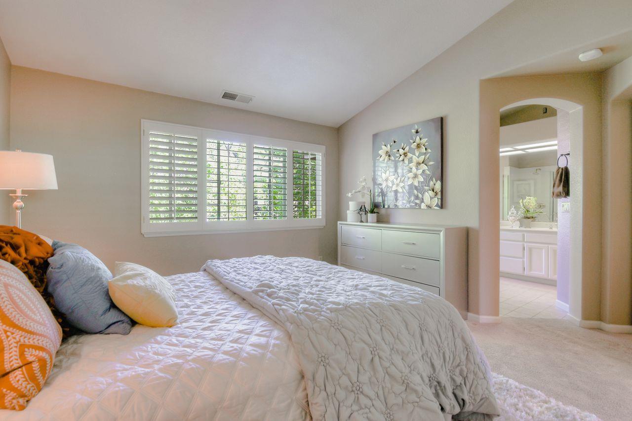 463 Mill River Lane San Jose, CA 95134 - Photo 19 of 30 a bedroom with a large bed and a closet